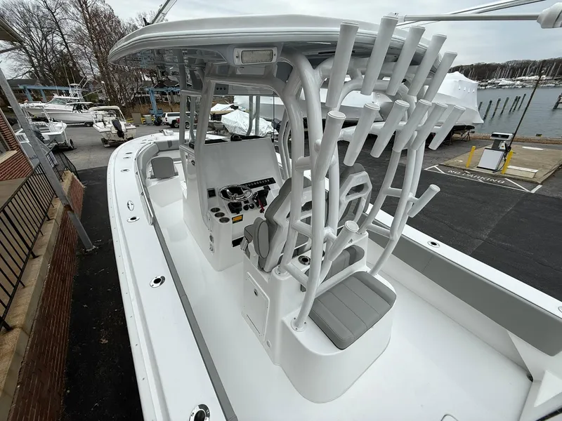 Slide: The Image of 2025 Cape Horn 28 XS boat with sleek design and advanced controls at a marina. - 11