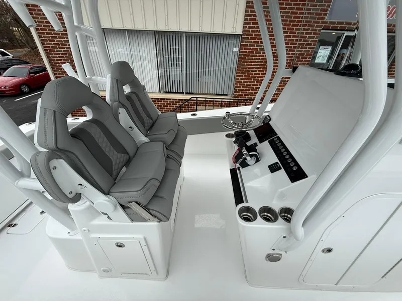 Slide: The Image of 2025 Cape Horn 28 XS boat interior with dual seats and control panel. - 14