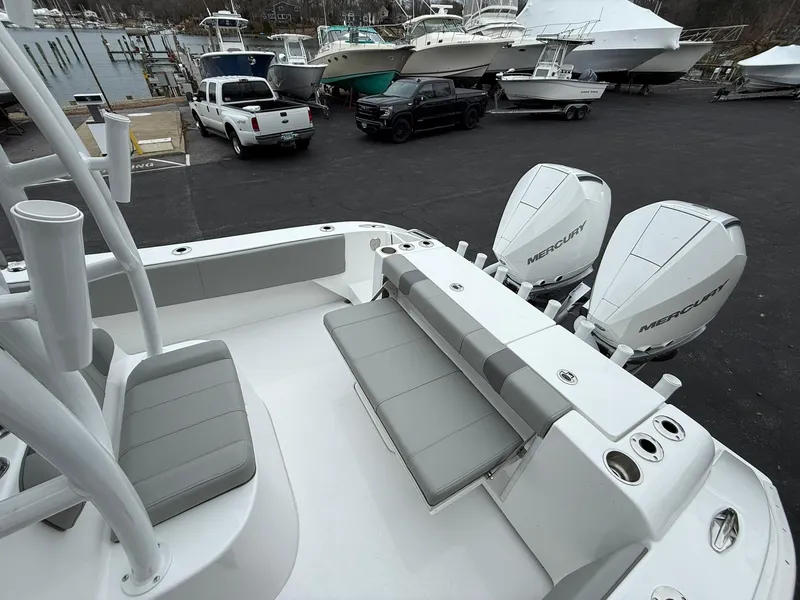 Slide: The Image of 2025 Cape Horn 28 XS boat with dual Mercury engines in a marina parking lot. - 18