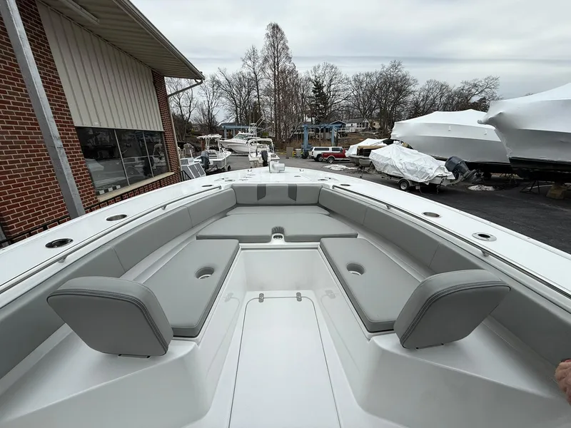 Slide: The Image of 2025 Cape Horn 28 XS boat with spacious seating and sleek design in a marina setting. - 3