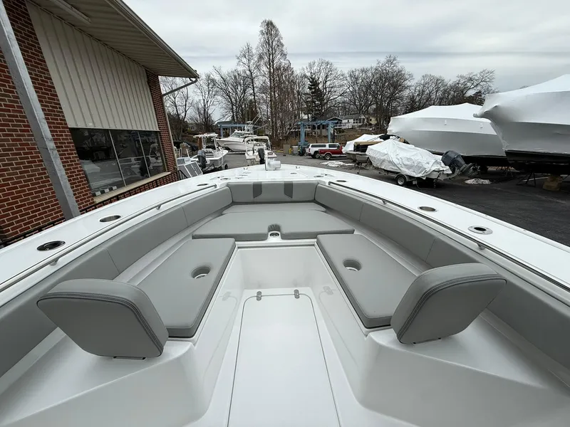 Slide: The Image of 2025 Cape Horn 28 XS boat with spacious seating and sleek design in a marina setting. - 4