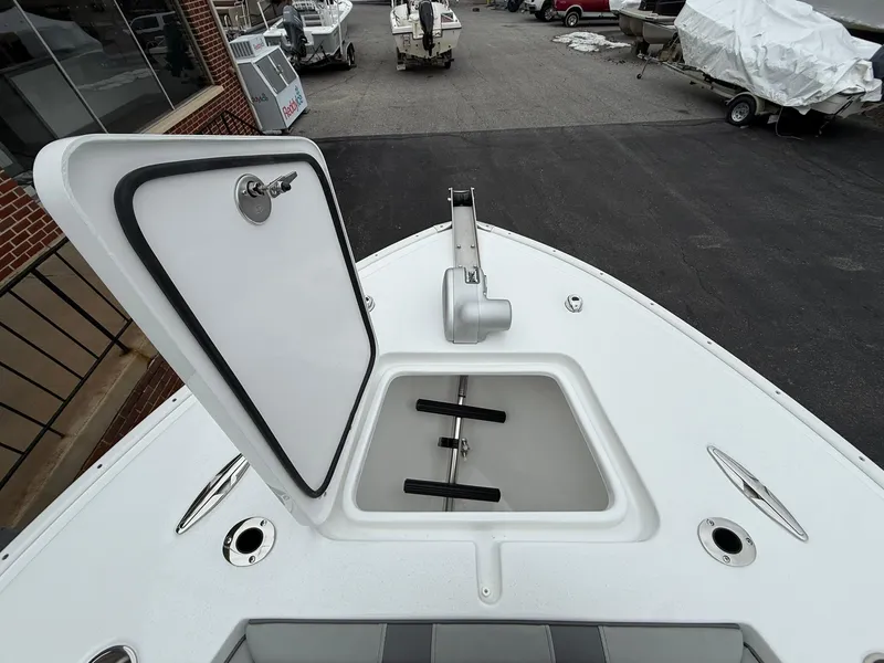 Slide: The Image of 2025 Cape Horn 28 XS boat with open hatch, docked in a marina. - 5