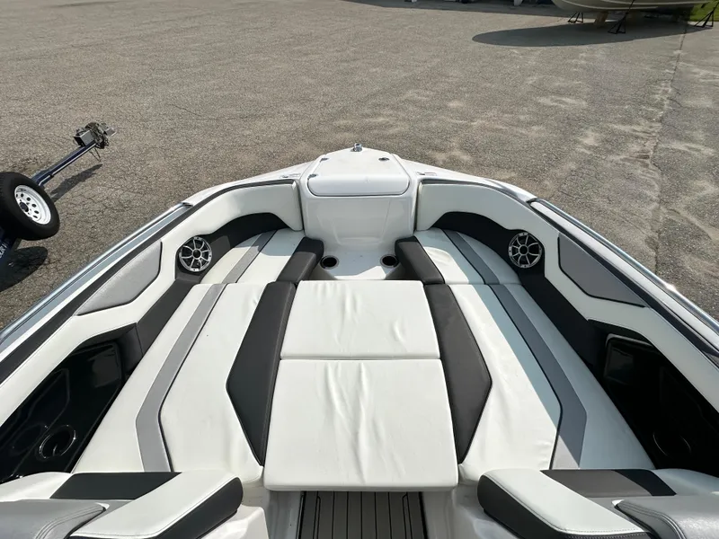 Slide: The Image of 2022 Yamaha Boats 212SD interior with sleek white and black seating, modern design. - 11