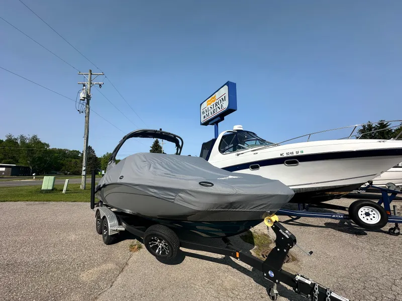 Slide: The Image of 2022 Yamaha Boats 212SD covered on trailer at dealership lot. - 17