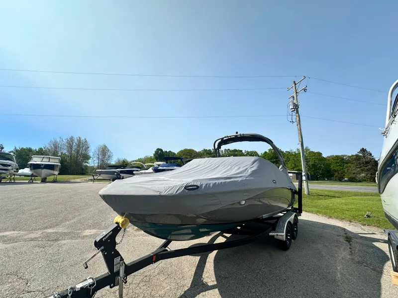 Slide: The Image of 2022 Yamaha Boats 212SD covered on trailer in outdoor parking lot. - 18