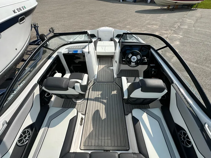 Slide: The Image of 2022 Yamaha Boats 212SD interior with sleek seating and modern dashboard design. - 4