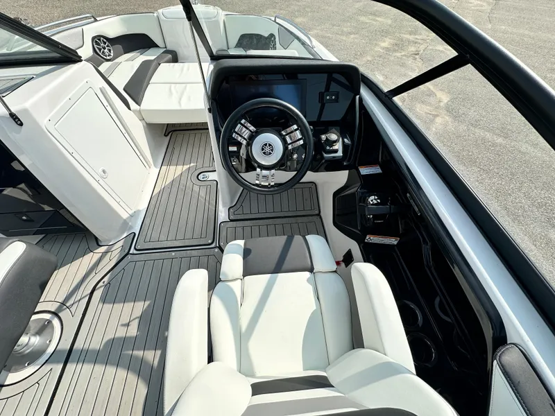 Slide: The Image of 2022 Yamaha Boats 212SD interior with modern helm and seating. - 6