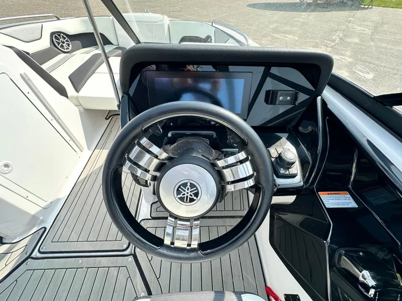 Slide: The Image of 2022 Yamaha Boats 212SD steering wheel and dashboard, featuring modern controls and sleek design. - 7