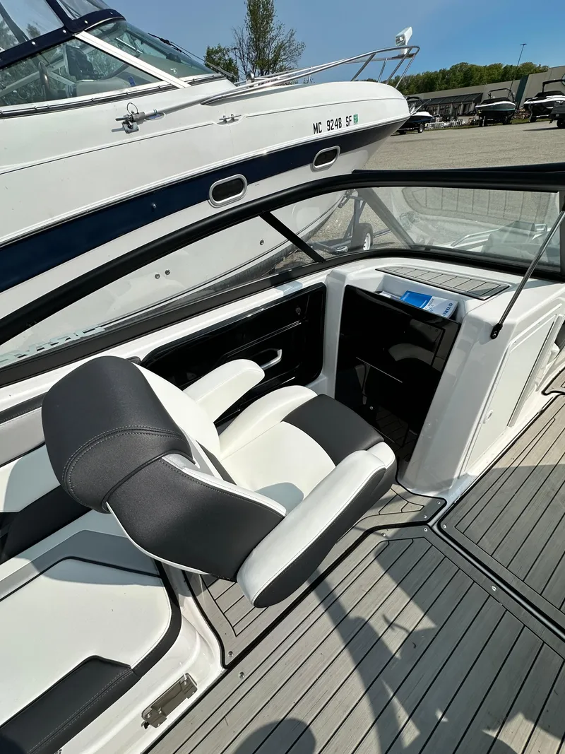 Slide: The Image of 2022 Yamaha Boats 212SD interior with sleek seating and modern dashboard design. - 9