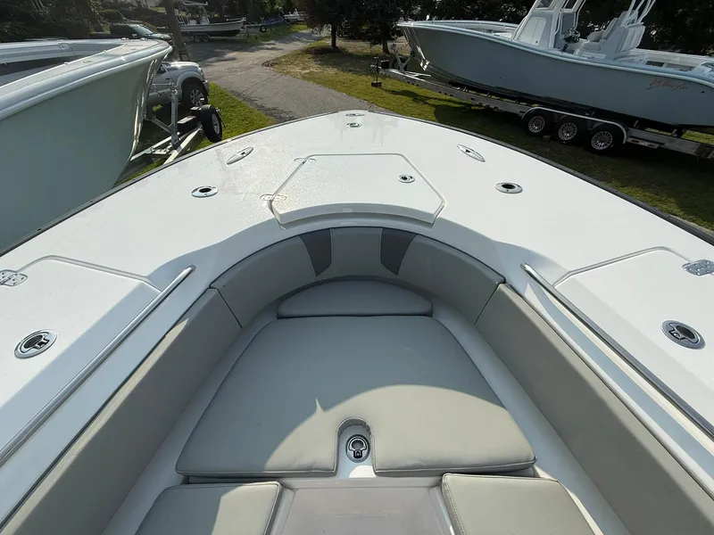 Slide: The Image of 2025 Cape Horn 32 XS boat interior with cushioned seating and storage compartments. - 17