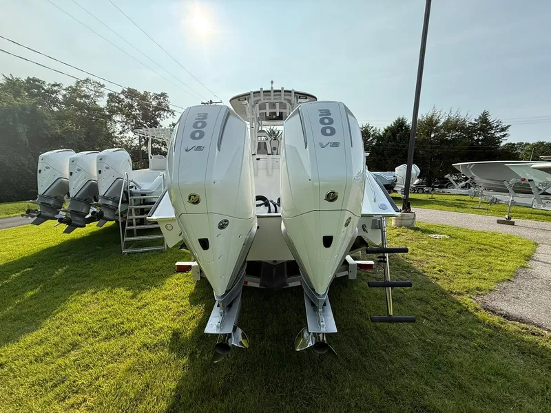 Slide: The Image of 2025 Cape Horn 32 XS boat with dual 300 horsepower engines, displayed on grass. - 4