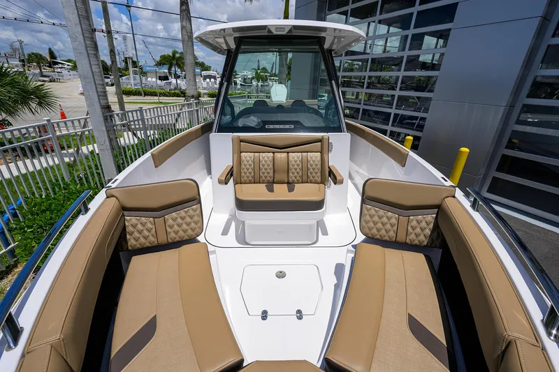 Slide: The Image of 2026 Monterey Elite 27 OB boat with luxurious tan seating and modern design. - 16