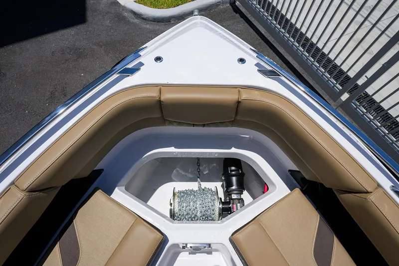 Slide: The Image of 2026 Monterey Elite 27 OB boat bow with tan seating and anchor storage. - 17