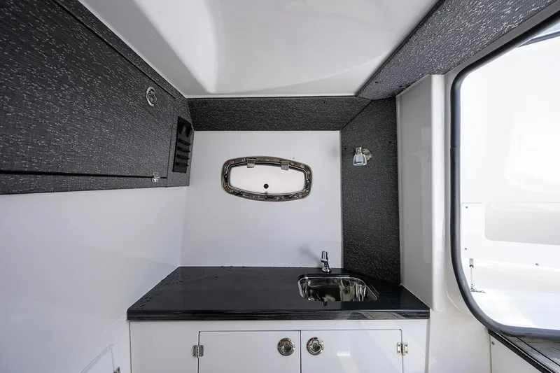 Slide: The Image of Interior of 2026 Monterey Elite 27 OB boat featuring a sleek sink and modern design. - 19