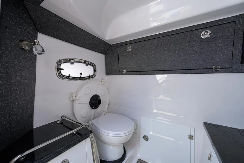Slide: The Image of Modern bathroom interior of 2026 Monterey Elite 27 OB boat, featuring sleek design and compact amenities. - 21