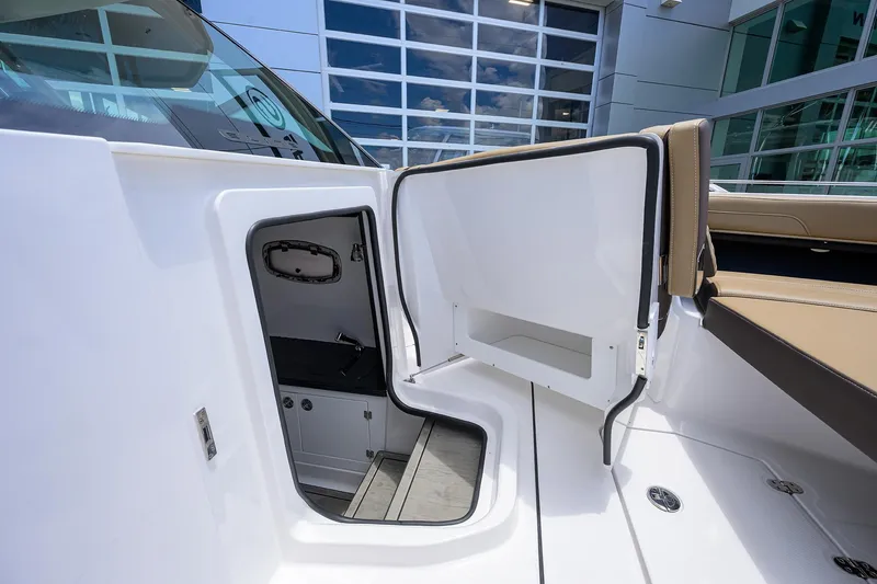 Slide: The Image of 2026 Monterey Elite 27 OB boat interior with open storage compartment and seating. - 22