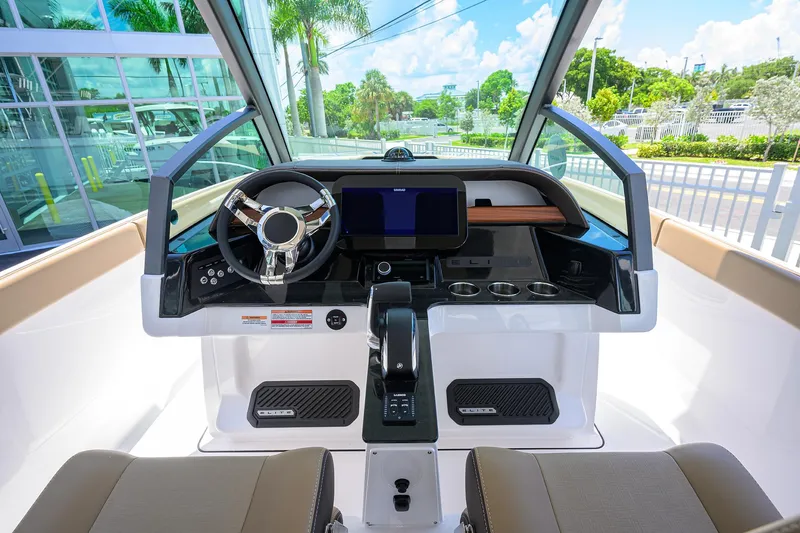 Slide: The Image of 2026 Monterey Elite 27 OB boat dashboard with modern steering and digital display. - 6