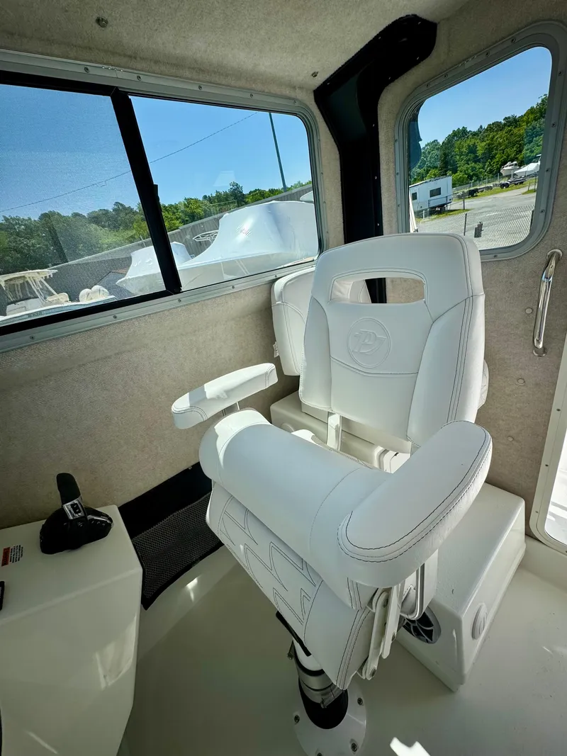 Slide: The Image of 2025 Parker 2820 XLD Sport Cabin interior with white captain's chair and control panel. - 10