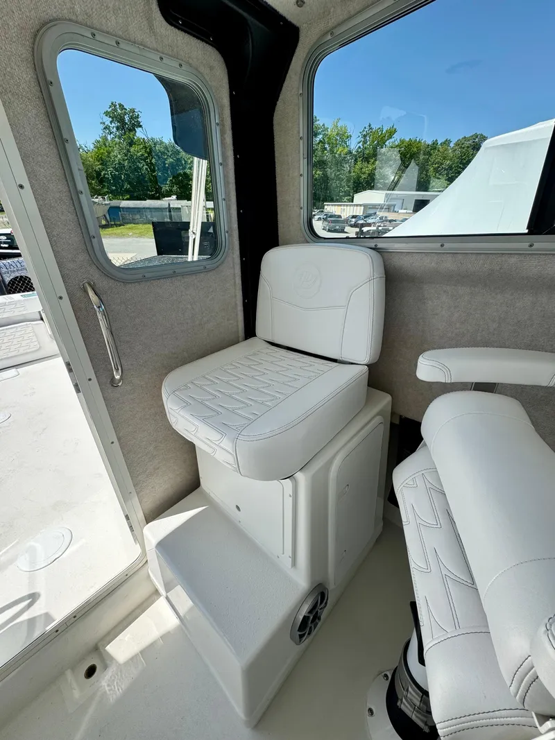 Slide: The Image of 2025 Parker 2820 XLD Sport Cabin interior with white seating and windows. - 12