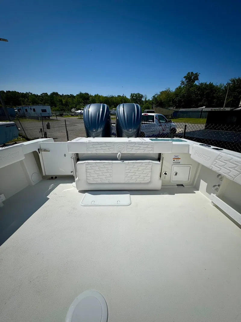 Slide: The Image of 2025 Parker 2820 XLD Sport Cabin boat with dual engines, spacious deck, and storage compartments. - 5