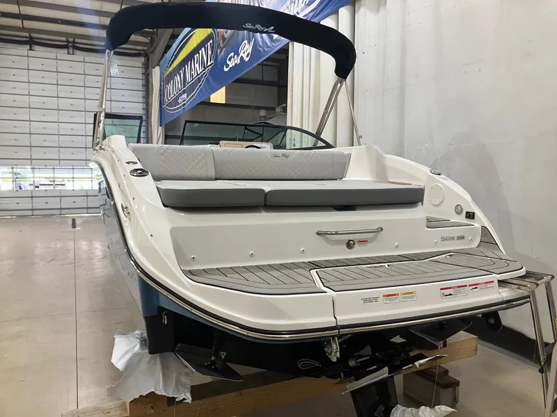 Slide: The Image of 2025 Sea Ray SDX 250 boat in showroom, rear view with seating and swim platform. - 3