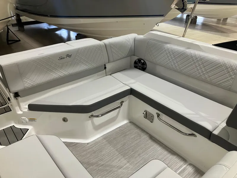 Slide: The Image of 2025 Sea Ray SDX 250 boat interior with white cushioned seating and sleek design. - 6