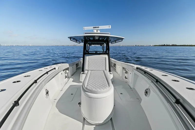 Slide: The Image of 2021 Yellowfin 39 boat on calm water, showcasing spacious deck and seating. - 14