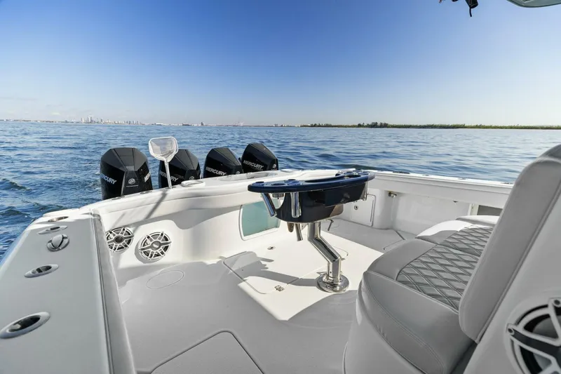 Slide: The Image of 2021 Yellowfin 39 boat interior with ocean view, featuring multiple outboard motors. - 20