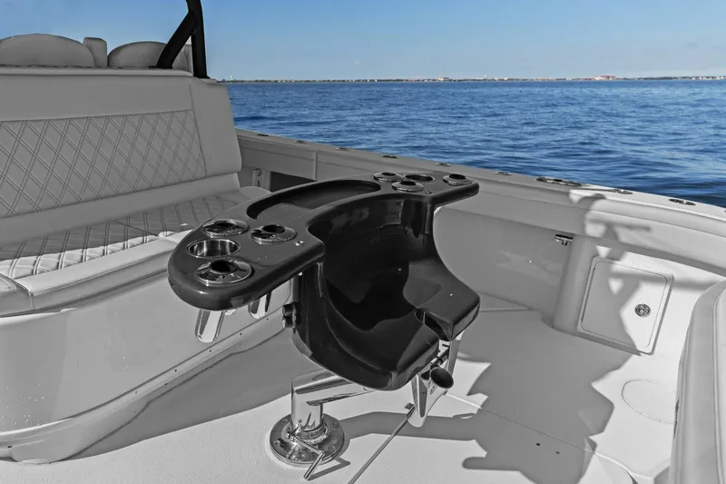 Slide: The Image of 2021 Yellowfin 39 boat interior with fishing chair and cup holders, overlooking the ocean. - 25