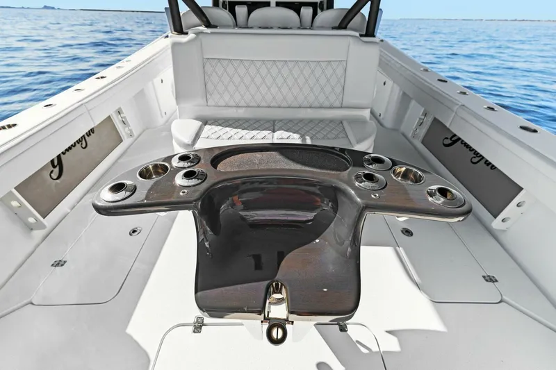Slide: The Image of 2021 Yellowfin 39 boat interior with fishing rod holders and seating, on open water. - 3