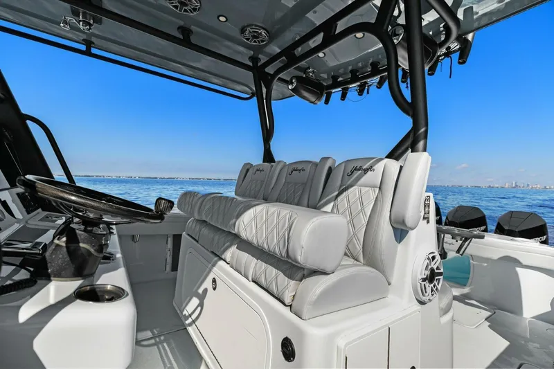 Slide: The Image of 2021 Yellowfin 39 boat interior with luxurious seating and modern controls on open water. - 32
