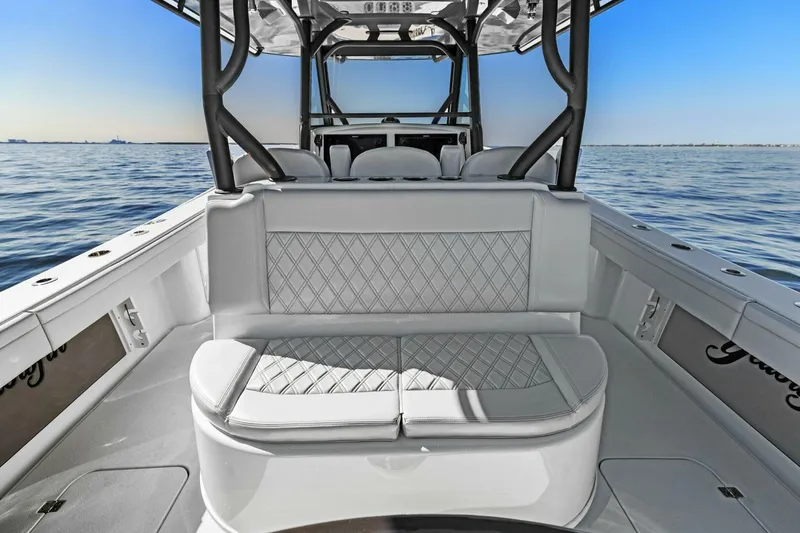 Slide: The Image of 2021 Yellowfin 39 boat interior with cushioned seating, on calm ocean water. - 33