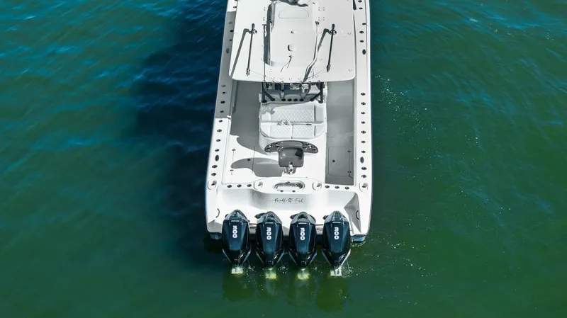 Slide: The Image of 2021 Yellowfin 39 boat with four outboard engines on green water. - 39