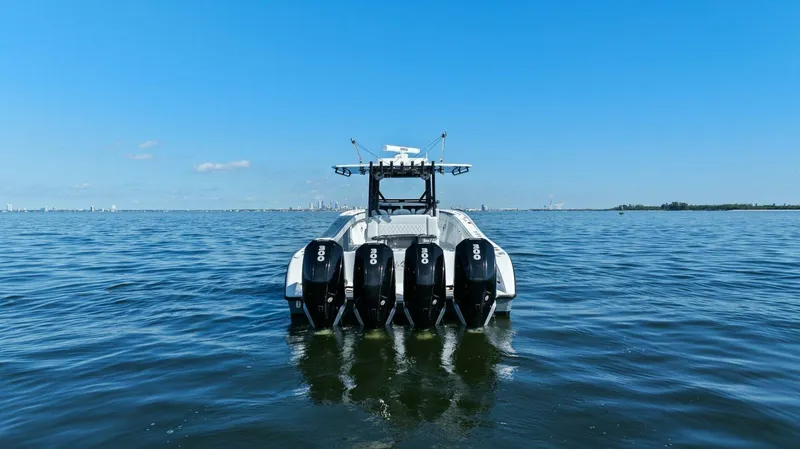 Slide: The Image of 2021 Yellowfin 39 boat with four engines on open water under clear blue sky. - 40