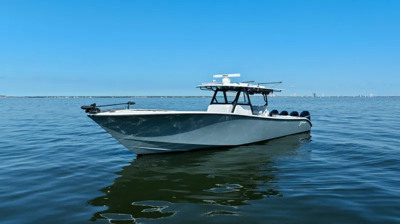 Slide: The Image of 2021 Yellowfin 39 boat on calm water under clear blue sky. - 46