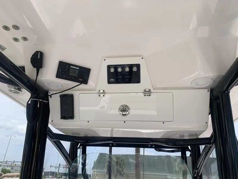 Slide: The Image of 2023 Sea Fox 268 Commander boat console with controls and storage compartment. - 20