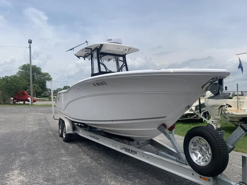 Slide: The Image of 2023 Sea Fox 268 Commander boat on trailer, parked outdoors under cloudy sky. - 6