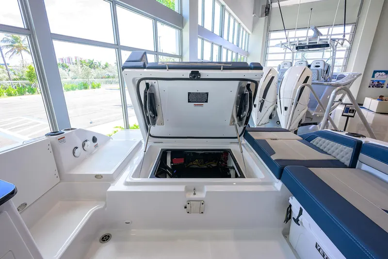 Slide: The Image of 2026 Monterey Elite 27 OB boat interior with open engine compartment, showcasing modern design and seating. - 12