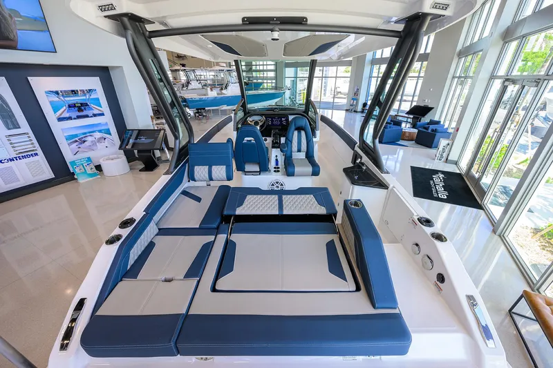 Slide: The Image of 2026 Monterey Elite 27 OB boat interior with blue seating in a showroom. - 15