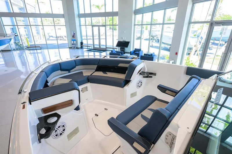 Slide: The Image of 2026 Monterey Elite 27 OB boat interior with blue seating in a showroom. - 20