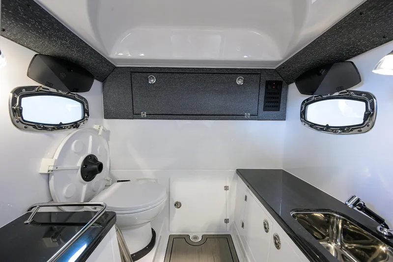 Slide: The Image of 2026 Monterey Elite 27 OB boat interior with modern bathroom and sleek design. - 21