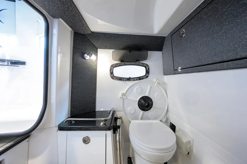 Slide: The Image of 2026 Monterey Elite 27 OB boat interior with modern bathroom amenities. - 23