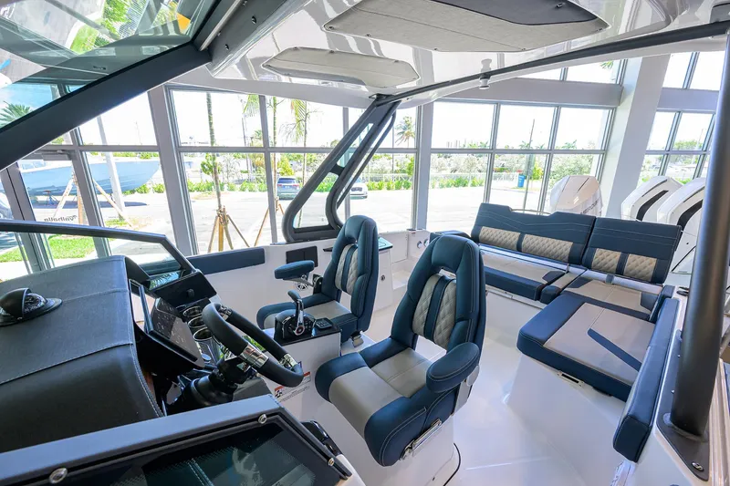 Slide: The Image of Interior of 2026 Monterey Elite 27 OB boat with luxurious seating and modern controls. - 4