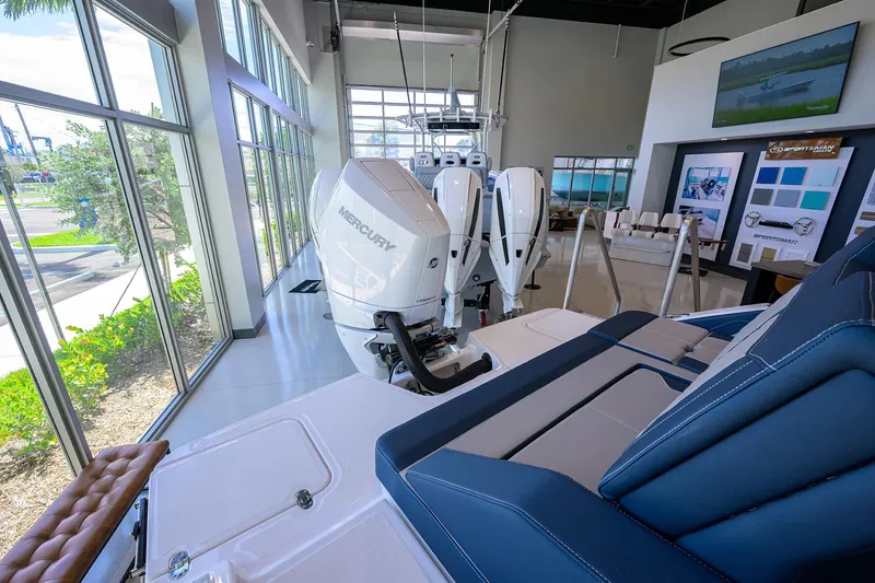 Slide: The Image of 2026 Monterey Elite 27 OB boat with Mercury engines in a showroom display. - 8