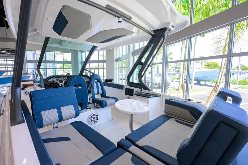 Slide: The Image of Luxurious 2026 Monterey Elite 27 OB boat interior with blue seating and modern design. - 9