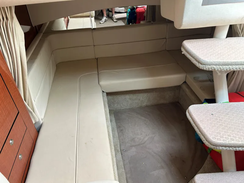 Slide: The Image of Interior cabin of 2005 Sea Ray 300 Sundancer with beige seating and steps. - 17