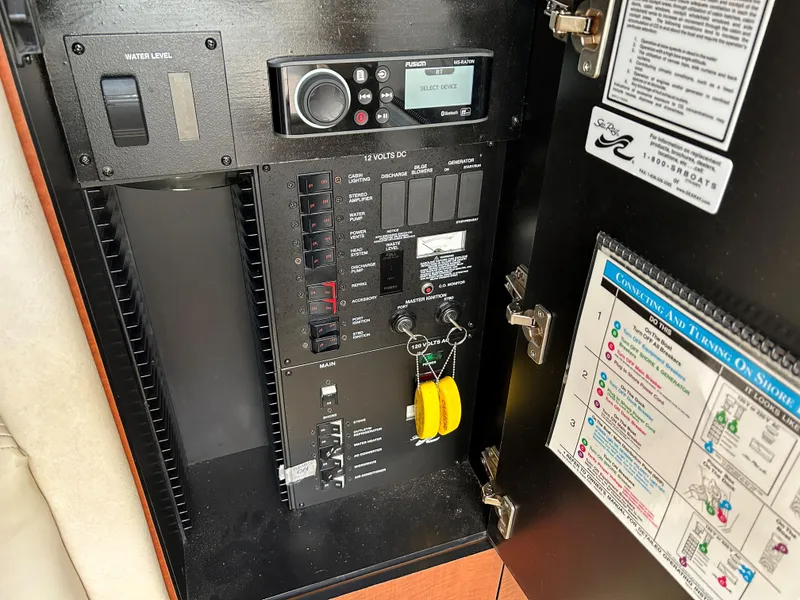 Slide: The Image of Electrical control panel of 2005 Sea Ray 300 Sundancer boat with switches and keys. - 19
