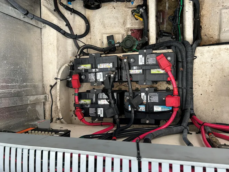 Slide: The Image of Battery compartment of a 2005 Sea Ray 300 Sundancer boat with wiring and connections. - 21
