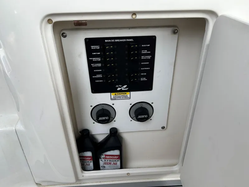 Slide: The Image of Electrical panel of 2005 Sea Ray 300 Sundancer with oil containers below. - 25