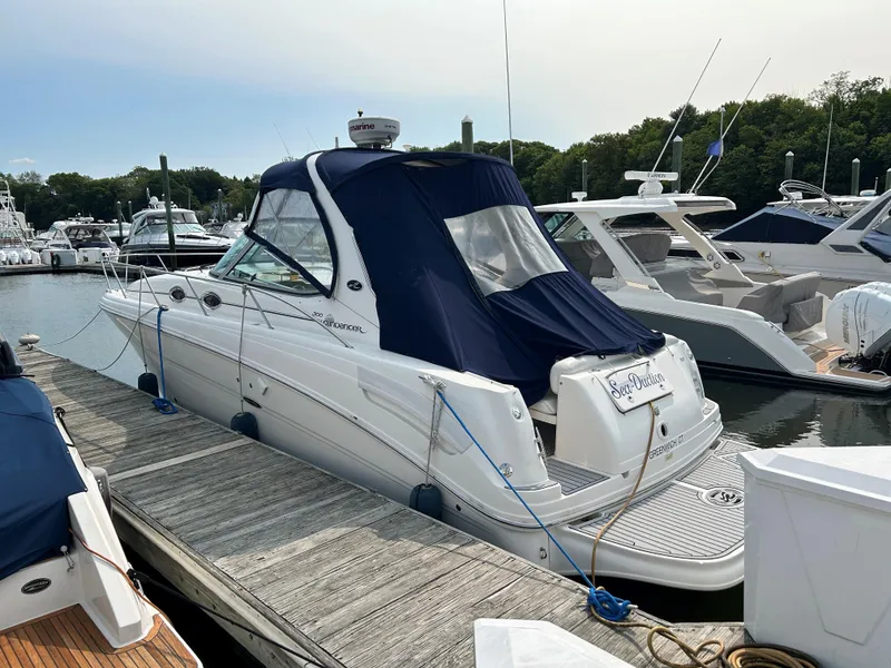 Slide: The Image of 2005 Sea Ray 300 Sundancer docked at marina with blue canopy. - 4